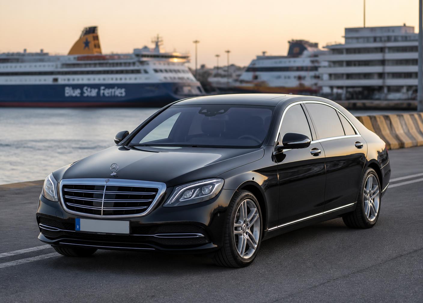 Black premium Mercedes-Benz sedan waiting at the Port of Piraeus at sunset